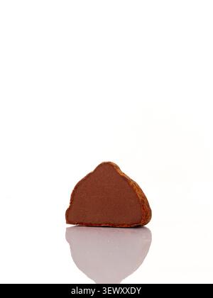 Chocolate truffle cut in half on white background Stock Photo