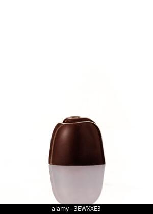 Single gourmet dark chocolate candy on white Stock Photo