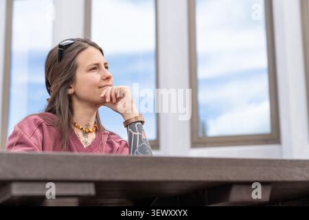 Young woman thinking contemplating future looking away Stock Photo