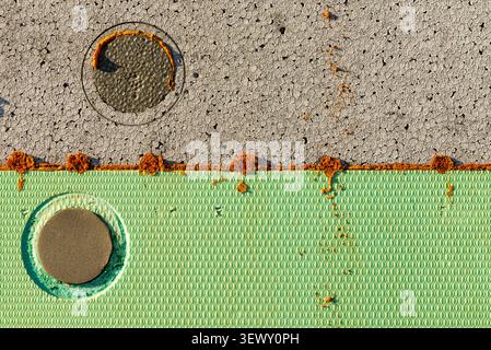 Close up of a green polystyrene foam panel with a fixed insulation dowel pin Stock Photo