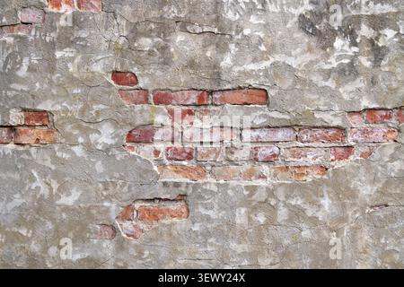 Detail of an old industrial wall - bricks with gray plaster Stock Photo