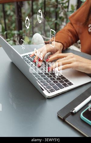Hands typing on laptop while interacting with a content management system overlay in a workspace Stock Photo