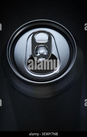 Close-up of an blank, bright black aluminum soda can resting on a table. Stock Photo