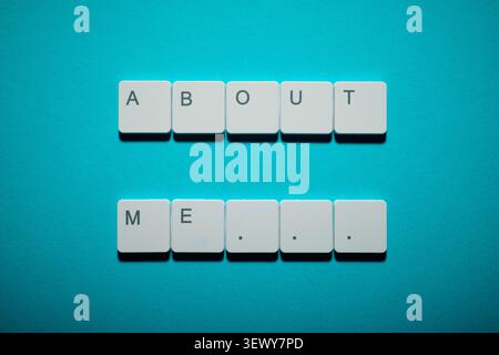 About me text written witk white keys of a keyboard on a blue table Stock Photo