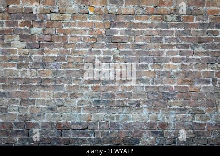 Aged weathered brick wall texture background with rustic urban masonry detail Stock Photo