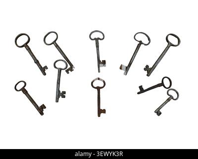 Several vintage rusty iron skeleton keys are scattered on a white background. These keys show various shapes and sizes. They are suitable for decorati Stock Photo
