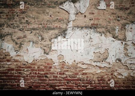 Old brick wall and peeling plaster Stock Photo