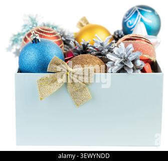 Christmas gift box filled with colorful baubles and silver pine cones isolated on white background Stock Photo