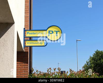 Pasian di Prato, Italy. June 27, 2026. PT Poste Italiane sign outside a local  branch with wall on the left and blue sky on background Stock Photo