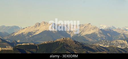 A majestic view of rugged mountain peaks under a clear sky, showcasing natural beauty. Alps Stock Photo