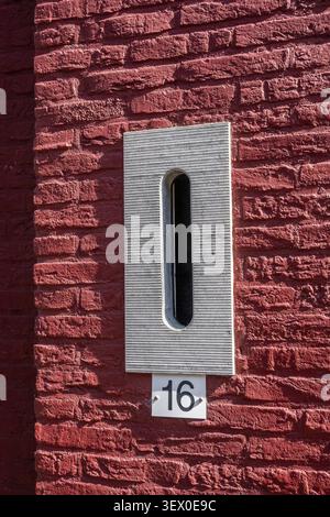 Modern stone mailbox on red brick wall in Leeuwarden, Leeuwarden, Friesland, the Netherlands Stock Photo