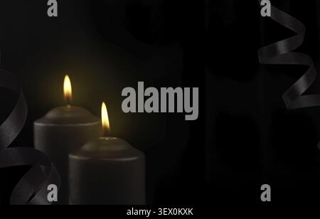 Two black burning candles on black background with waved satin ribbons Stock Photo