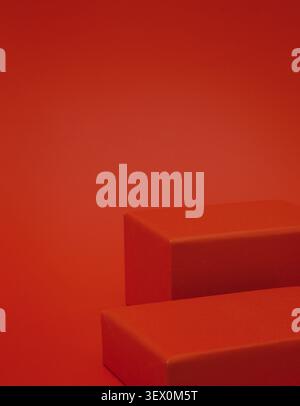 Two empty red rectangular podiums of different heights on red background Stock Photo