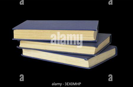 Stack of old books with blue cover isolated on black Stock Photo