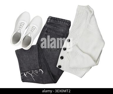 Set of white knitted cardigan, black jeans and leather sneackers isolated on white. Flat lay. Trendy casual outfit. Look of the day Stock Photo