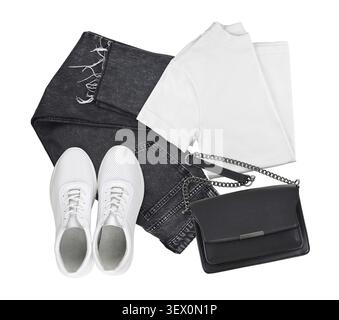 Set of white t-shirt, black jeans, bag and leather sneackers isolated on white. Flat lay. Trendy casual monohrome outfit. Look of the day Stock Photo