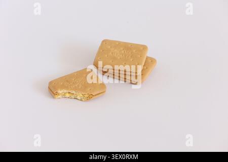 Cream Sandwich Biscuits On White Background With One Bitten Cookie And Two Whole Biscuits Stock Photo