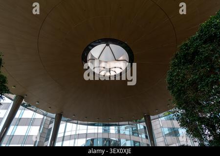 circular wooden ceiling element with a central skylight, Exchange Square lobby, Hong Kong Stock Photo