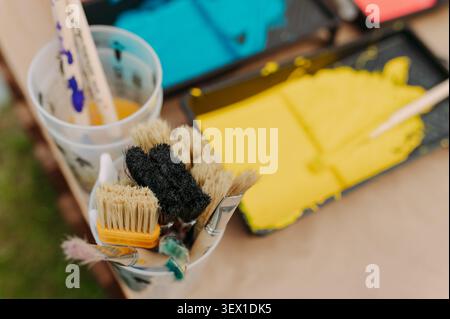 Painting tools and yellow paint tray prepared for creative workshop Stock Photo