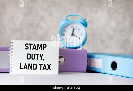 SDLT - stamp duty for land tax - is indicated on the notebook next to the office supplies Stock Photo