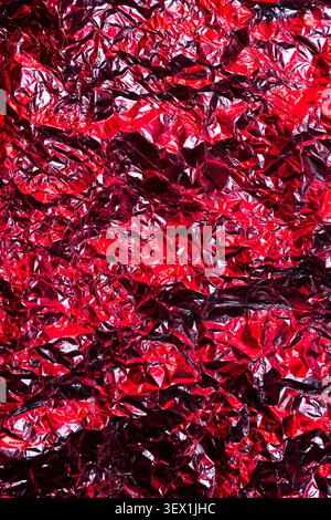 Abstract Red Metallic Foil Surface Texture Background With Wrinkles And Crinkles Stock Photo