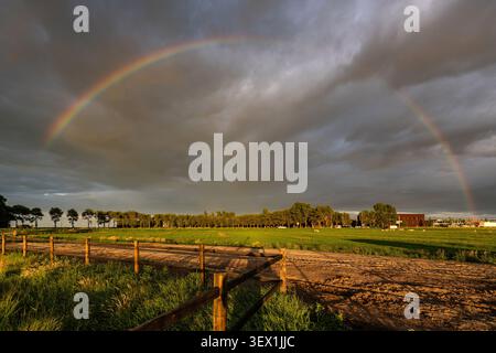 full-arc rainbow stretching across a dramatic sky Stock Photo