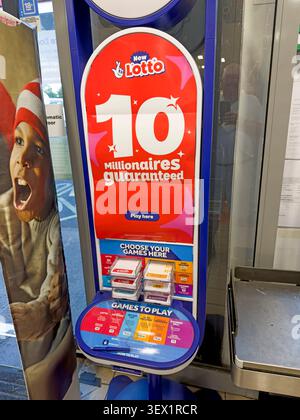 UK shop lottery terminal advertises 10 guaranteed millionaires amid debate over gambling normalisation, affordability and harm Stock Photo