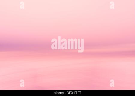 Colourful blurred coastal in pink hues background horizontal texture created from intentional camera movement. Stock Photo
