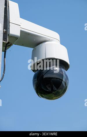A modern black dome surveillance camera mounted on a building provides wide-angle security monitoring in multiple directions. Belgium 21 JUN 2026 Phot Stock Photo
