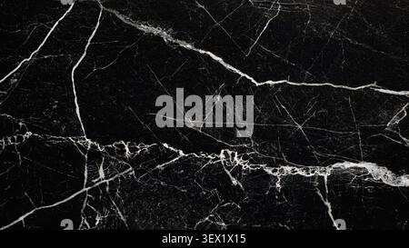 Dark background shows white marble-like veins. Natural lines create intricate, flowing patterns. Perfect for luxury design and interior applications Stock Photo
