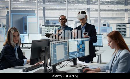 Microchip research facility experts in office using VR headset to examine semiconductor substrates. Employees using virtual reality simulation to inspect silicon wafers, camera A Stock Photo