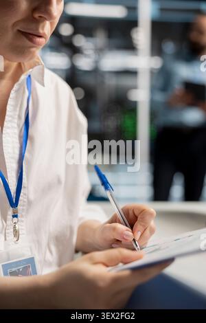 System operator uses a desktop computer in a data center to support supercomputer management and reliable server workflows. Stock Photo