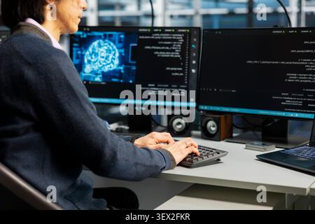 Data center engineer uses a digital device in a data center to support automation monitoring and reliable server workflows. Stock Photo