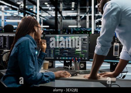 System administrator reviews node tree software to analyze datasets and improve server infrastructure performance. Stock Photo