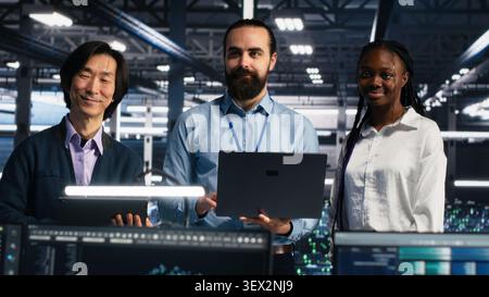 Engineers program on a computer workstation in a data center with generative AI assistance. Stock Photo
