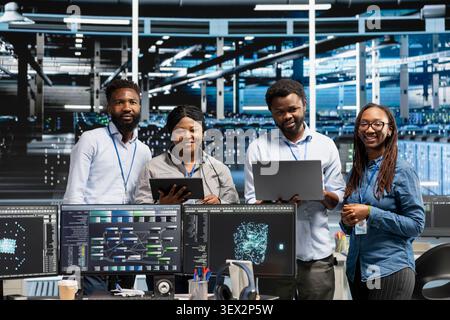 Friendly computing hub engineers working with AI algorithms and node trees categorizing and clustering unstructured data with happy server facility team members working with Natural Language. Stock Photo