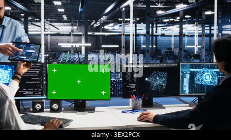 Data infrastructure center team supervisor overseeing team of technicians managing AI systems. Stock Photo