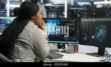 System administrator uses machine learning node tree software to analyze infrastructure in a data center. Stock Photo