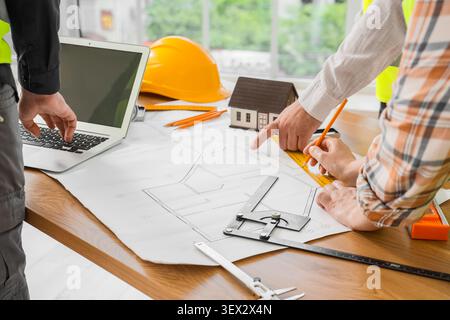 Architects working on house blueprint with tools and laptop Stock Photo
