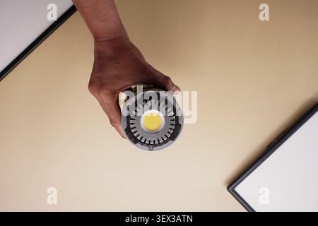 Holding a round flashlight in a person's hand Stock Photo