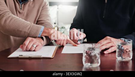 Hands, person and advisor with documents in meeting, finance report and form for loan application. People, consultant and reading at house with Stock Photo