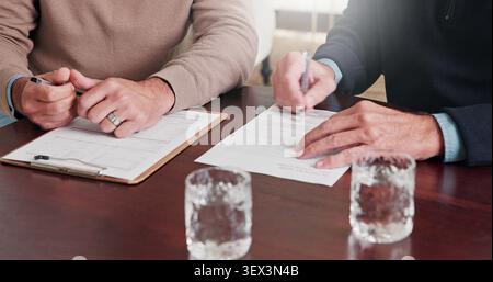Hands, person and writing on document with advisor, finance report and form for loan application. People, consultant and signature at house with Stock Photo