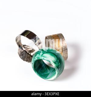 Three decorative napkin rings in silver gold and green marble on white background Stock Photo