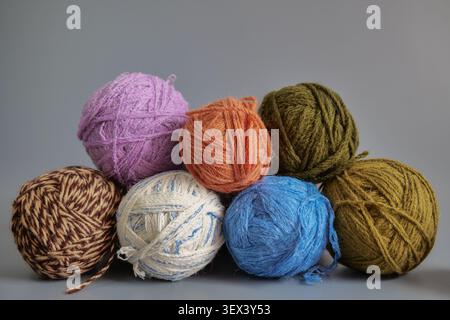Colorful knitting yarn balls against grey background Stock Photo