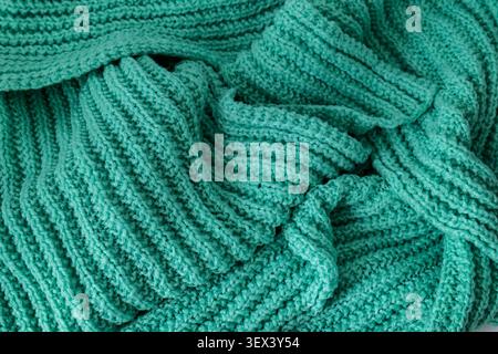 Turquoise knitted fabric texture background with folds Stock Photo