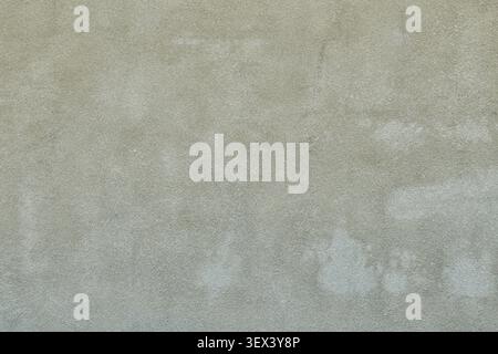 Full frame background of an old weathered grey stucco wall with grainy concrete plaster texture. Neutral monochrome architectural surface backdrop for Stock Photo
