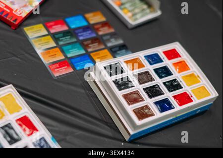 Watercolor paint palette with color chart on artist workspace Stock Photo