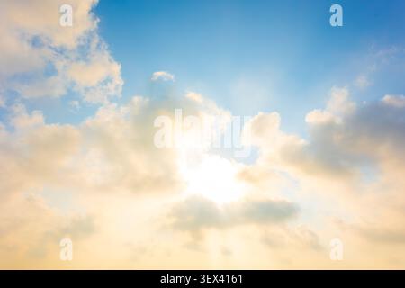 Heaven sky, Beautiful cloudy blue sky, morning sun rise with sunny bright shining golden light ray from dark cloud, new years background or heaven gat Stock Photo