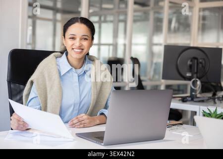 Happy female manager looking at camera Stock Photo