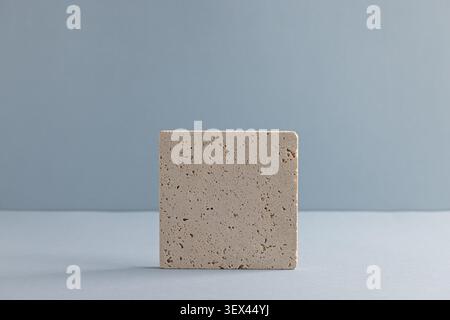 Minimalist Design: Textured Stone Tile on Blue Background for Interior Decoration Stock Photo